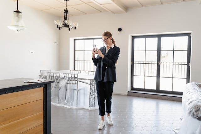 real estate agent taking pictures of rental unit
