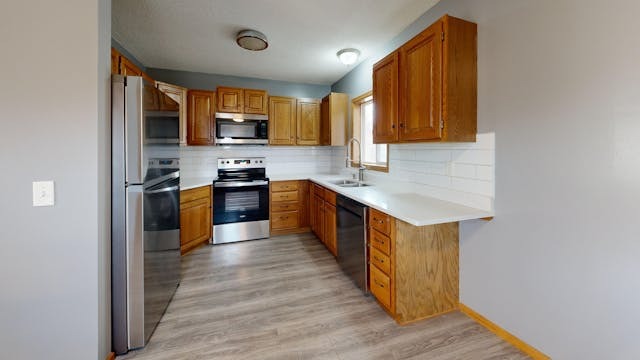kitchen with brown cupboards and drawers