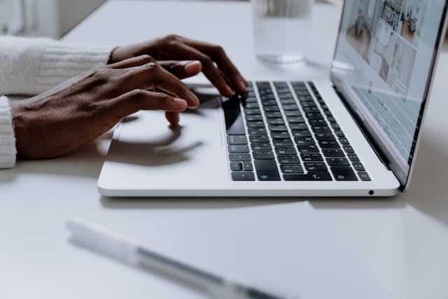 Person Using laptop on White Table