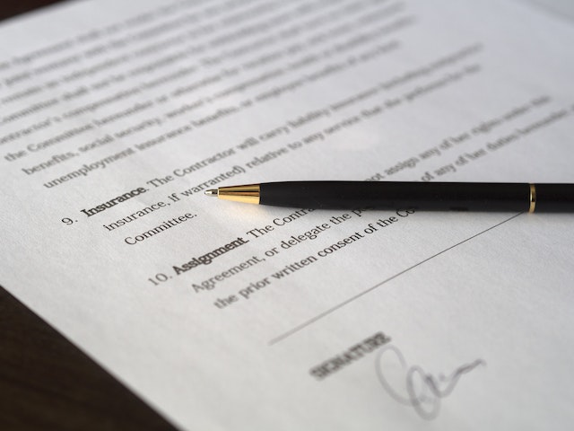 a contract with a pen on top of it