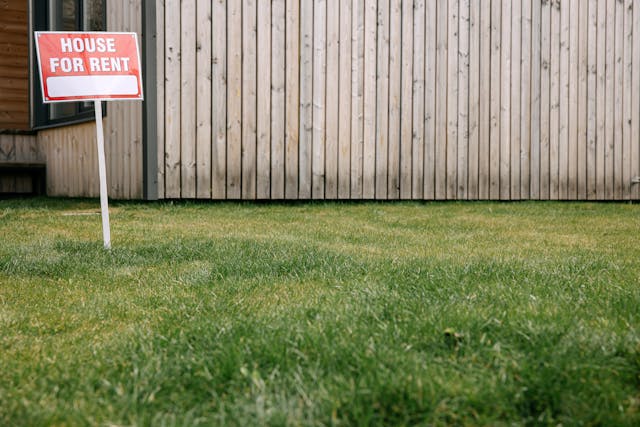 house for rent sign infront of wooden building