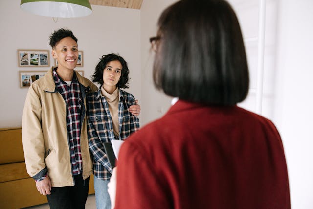 landlord talking to two tenants