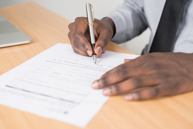 person signing a rental document
