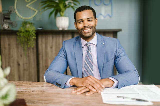 person sitting at a table with documents