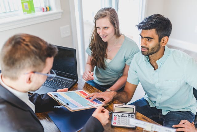 real estate expert going over purchasing details with buyers