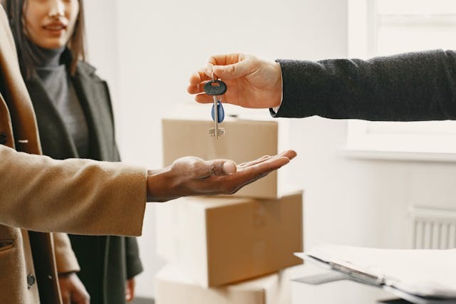 person passing keys to another