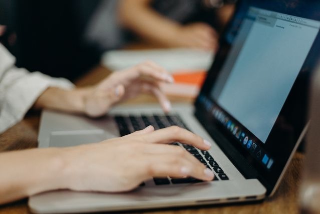 person typing on a laptop