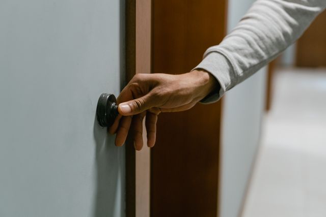 hand pressing a doorbell